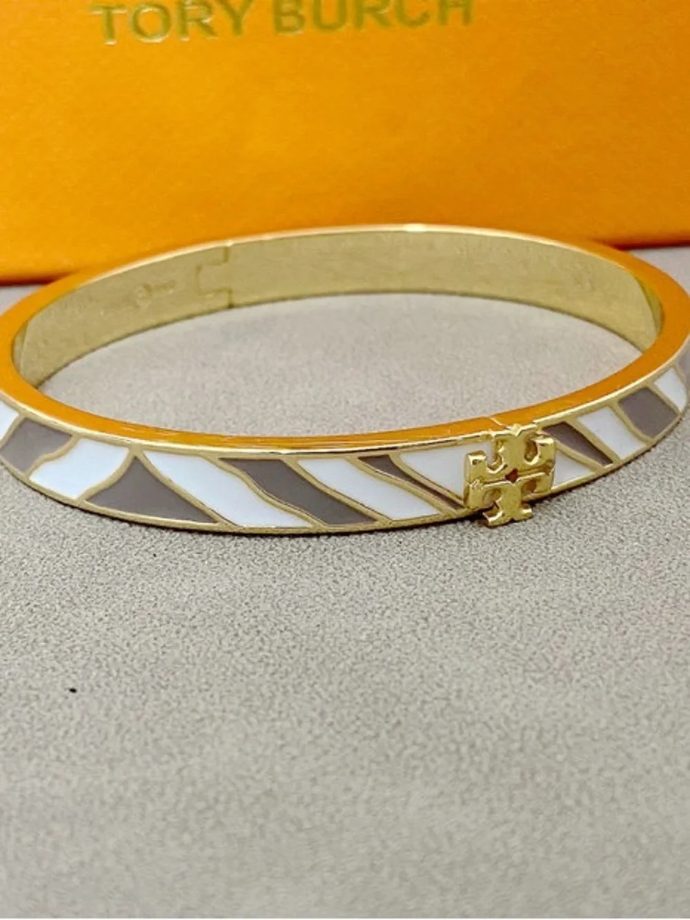 Tory Burch Gold Bracelet with White and Light Gray Enamel Stripes